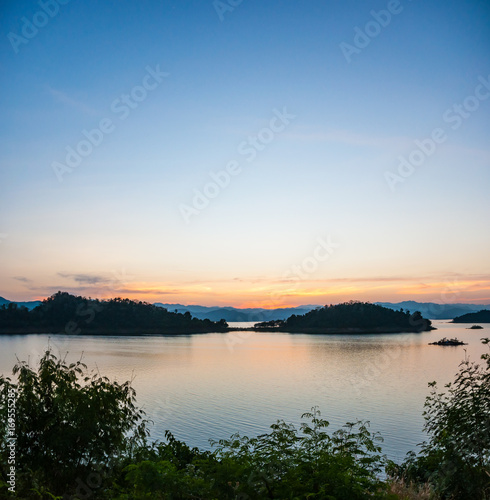 Landscape view of tranquil mountain and lake at suset, panorama view