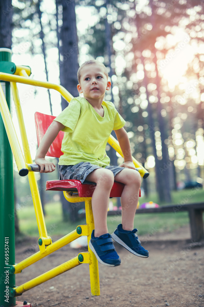 Boy with exercise machines in the park Boy with exercise machines in the park