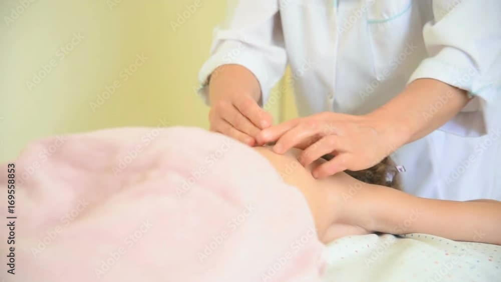 therapist making massage on girl back therapist making massage on girl back