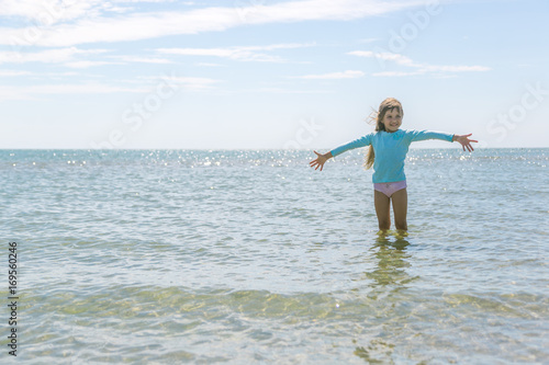 A little girl is enjoying sea water