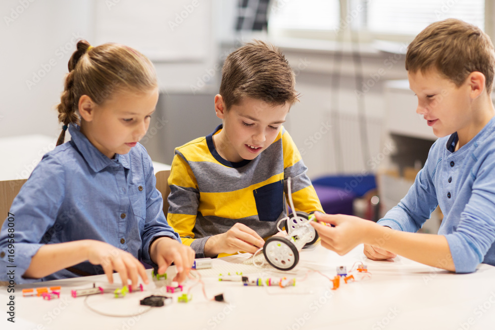 happy children building robots at robotics school happy children building robots at robotics school