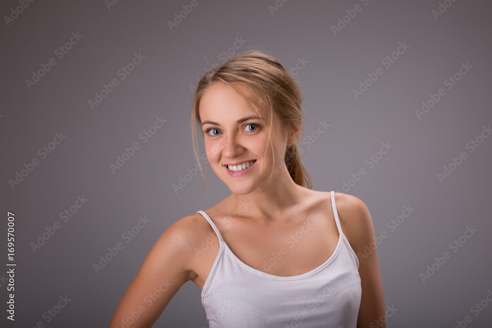 Beauty of woman with no make up on gray background in studio photo. Fresh clean look. Healthy skin