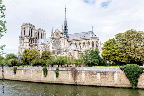Side view on the Notre Dame church during the cloudy weather in Paris