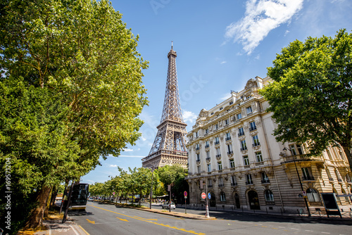 View from below on the beautiful buildings and Eiffel tower during the sunny weather in Paris