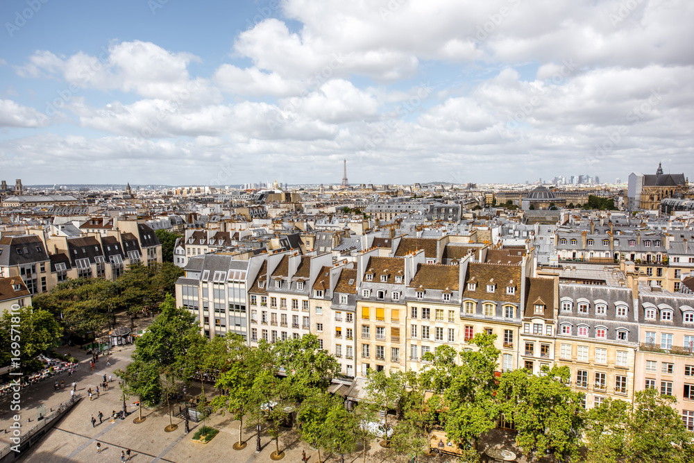 Aerial cityscape view on the beautiful buildings and Eiffel tower on the horizon during the cloudy weather in Paris