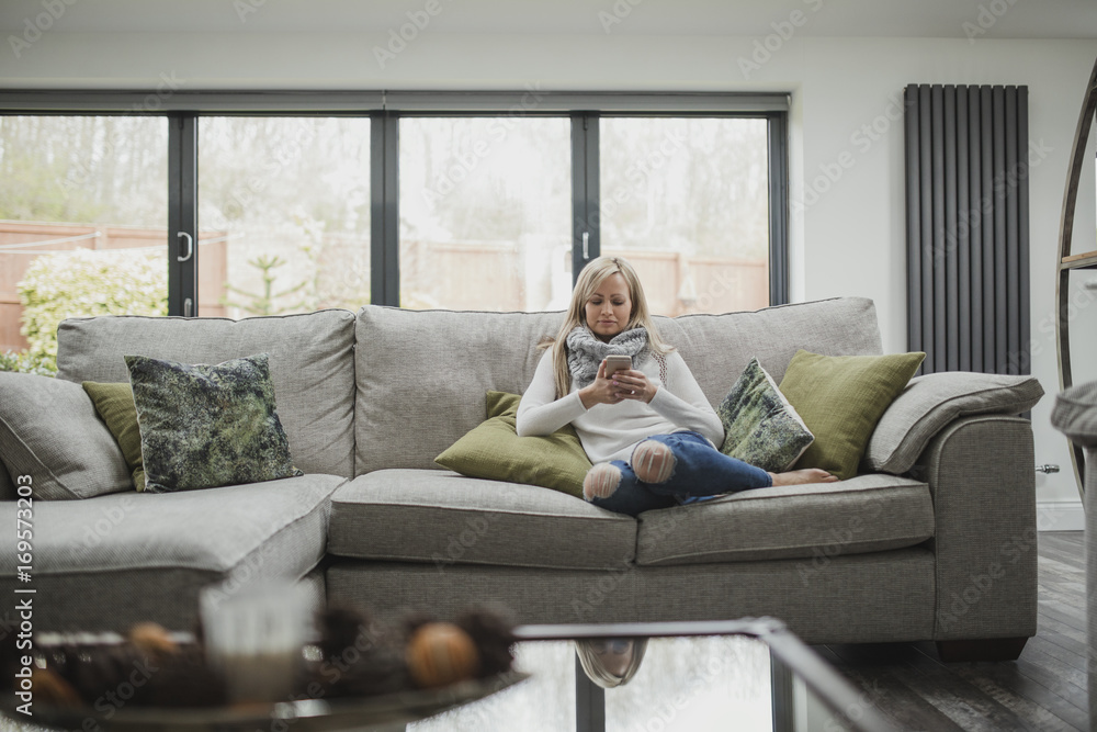 Woman Using Smartphone At Home Woman Using Smartphone At Home