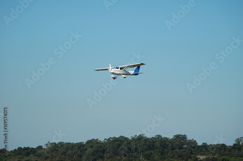 Obraz na plátně single engine monoplane landing in a small town airport