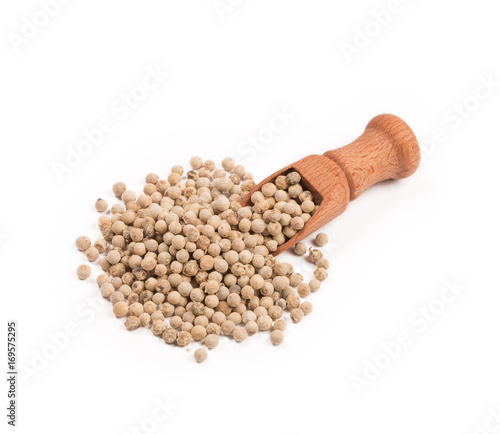 Wooden shovel with white pepper scattered from it