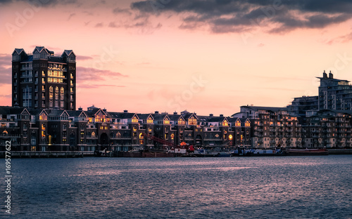London, England - February 19, 2016 - River Thames at sunset at Battersea Riverside, with apartment buildings of Fulham.