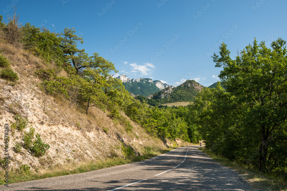 Long winding asphalt road through the mountains.