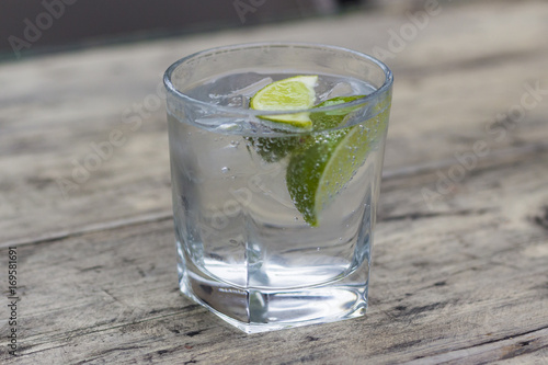 Gin and tonic with slice of lime in a glass