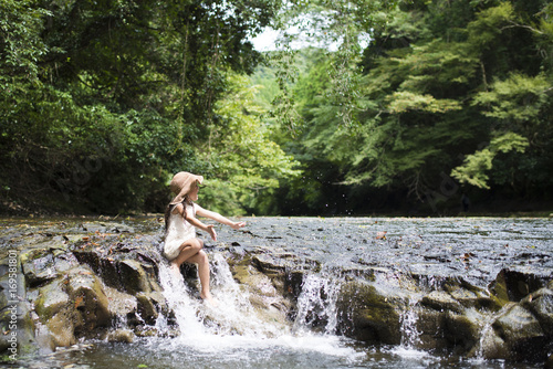 Little girl playing in the mountain stream