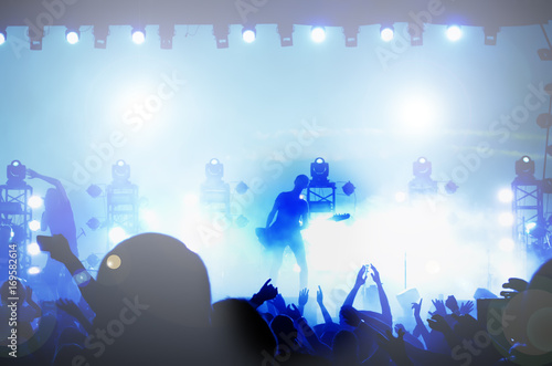 Rock stars musicians on the big stage. Guitarist guitar player. Silhouette in the light of street lamps.