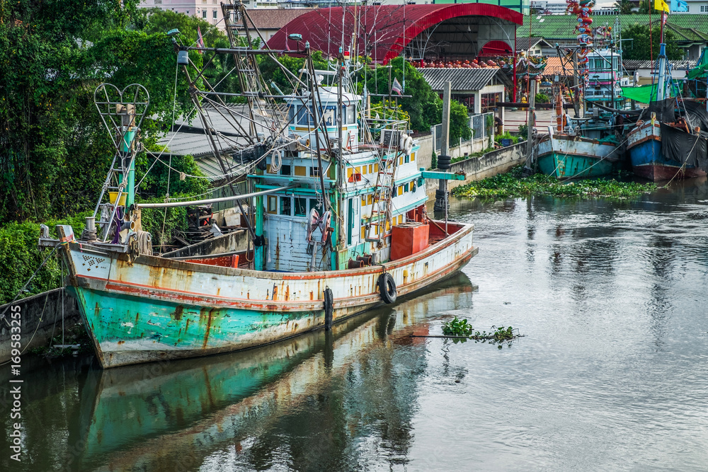Many fishing boats docked in the canal