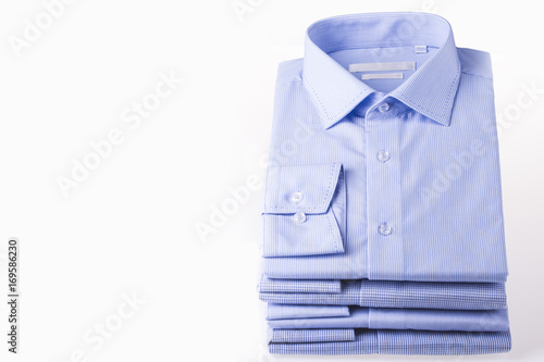Men's shirts folded in a pack on a white background