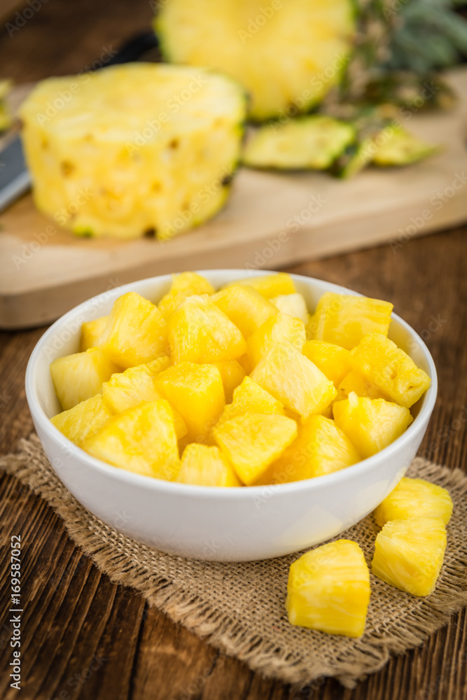 Portion of Pineapple (sliced) on wooden background, selective focus Portion of Pineapple (sliced) on wooden background, selective focus
