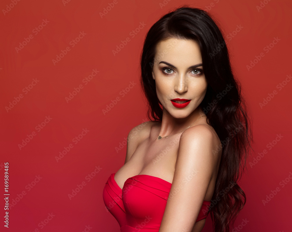 Beautiful female model posing on red background