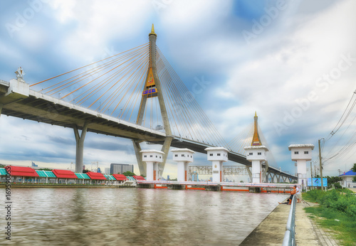 SAMUT PRAKAN, THAILAND - AUGUST 22, 2017: View from Lat Pho canal floodgates with Bhumibol bridge 1 and local people lifestyle. The bridge links Bangkok and Samut Prakan province