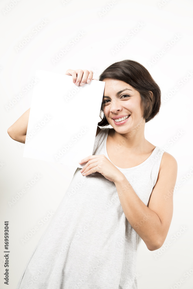 Beautiful young woman holding a blank sheet of paper Beautiful young woman holding a blank sheet of paper