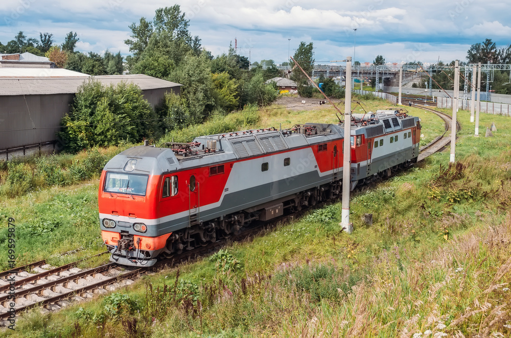 Naklejka premium Attached to each other electric locomotive and diesel locomotive at the turn of the Iron Dog