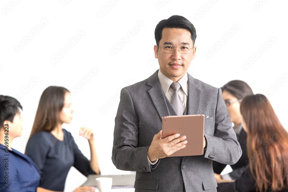 Asian Businessman using Tablet at front of business meeting Group, Businessman with leader concept, 30-40 year old. Asian Businessman using Tablet at front of business meeting Group, Businessman with leader concept, 30-40 year old.