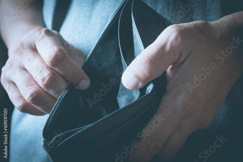 Close-up woman standing and holding the wallet empty of money