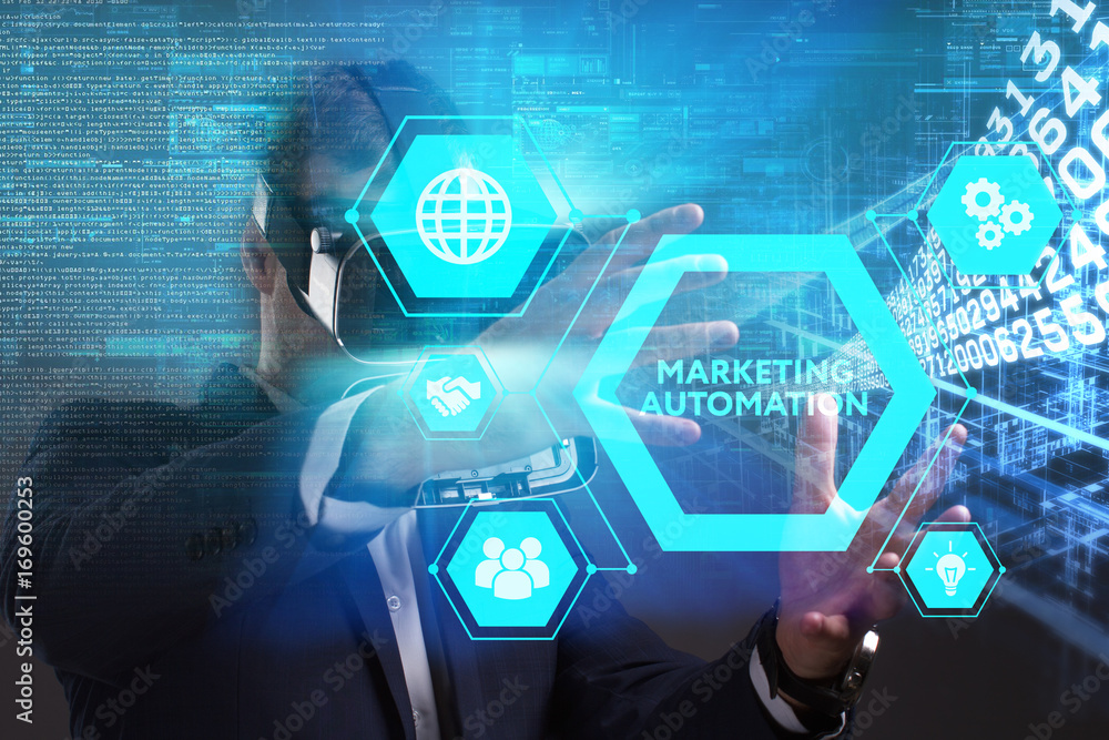 Business, Technology, Internet and network concept. Young businessman working in virtual reality glasses sees the inscription: Marketing automation Business, Technology, Internet and network concept. Young businessman working in virtual reality glasses sees the inscription: Marketing automation