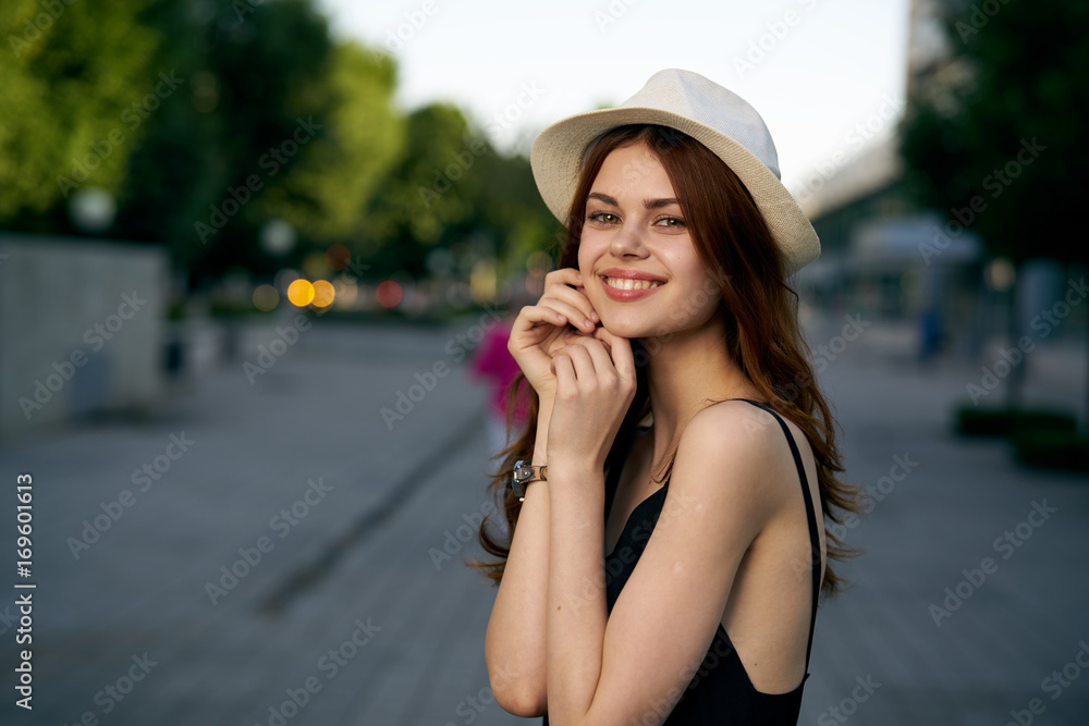 Woman with hat in the city, smile, portrait