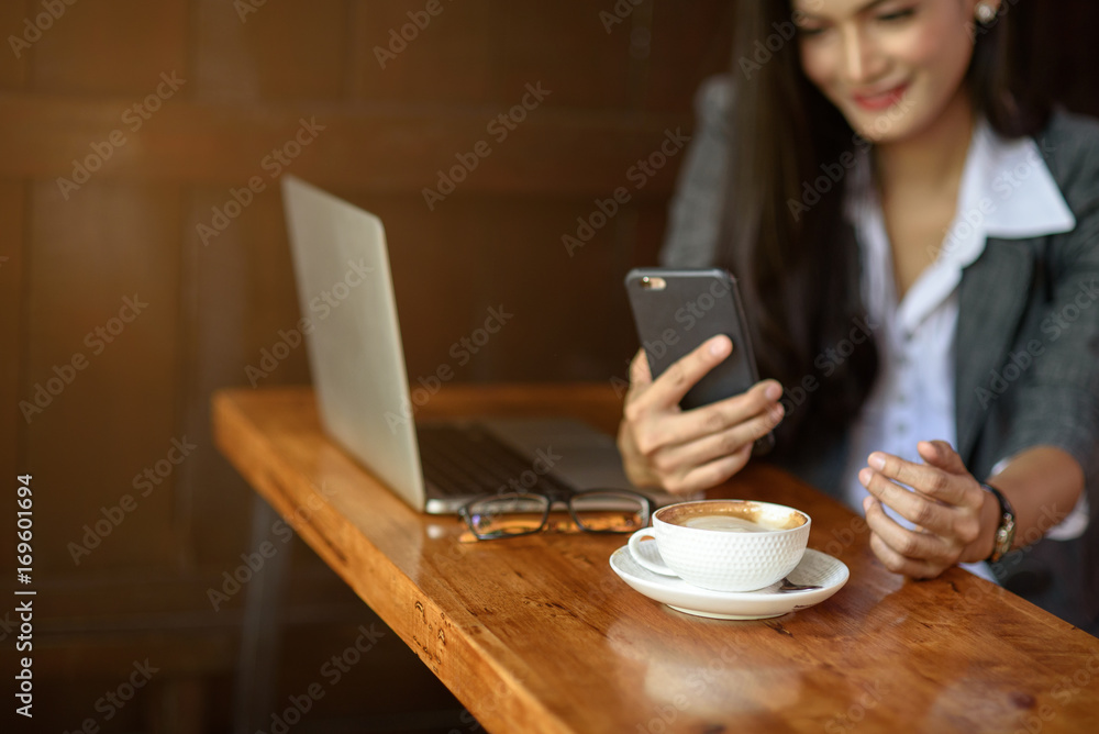 Young female freelancer checking email on cell during coffee break. Business concept. Young female freelancer checking email on cell during coffee break. Business concept.