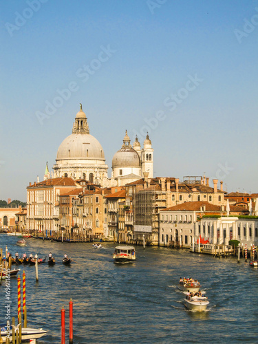 Grand Canal with boats and gondolas and the Basilica di Santa Maria della Salute in the background (Venice, Italy) © Helissa
