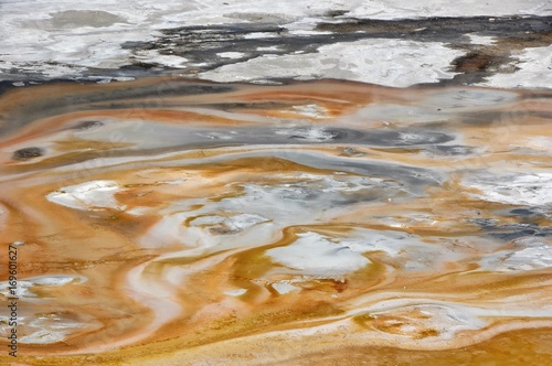 Overhead view of a vast geyser basin, toxic badlands.