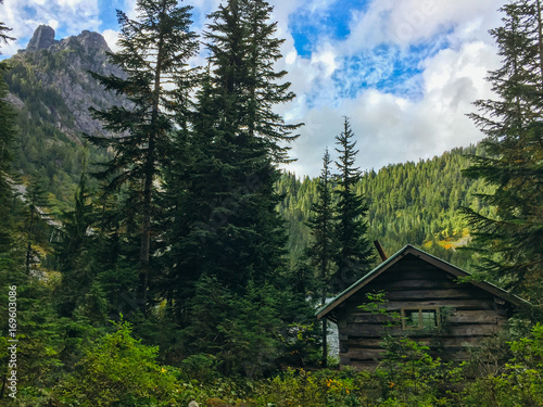 Hidden Forest Cabin At Edge Of Mountain Lake photo