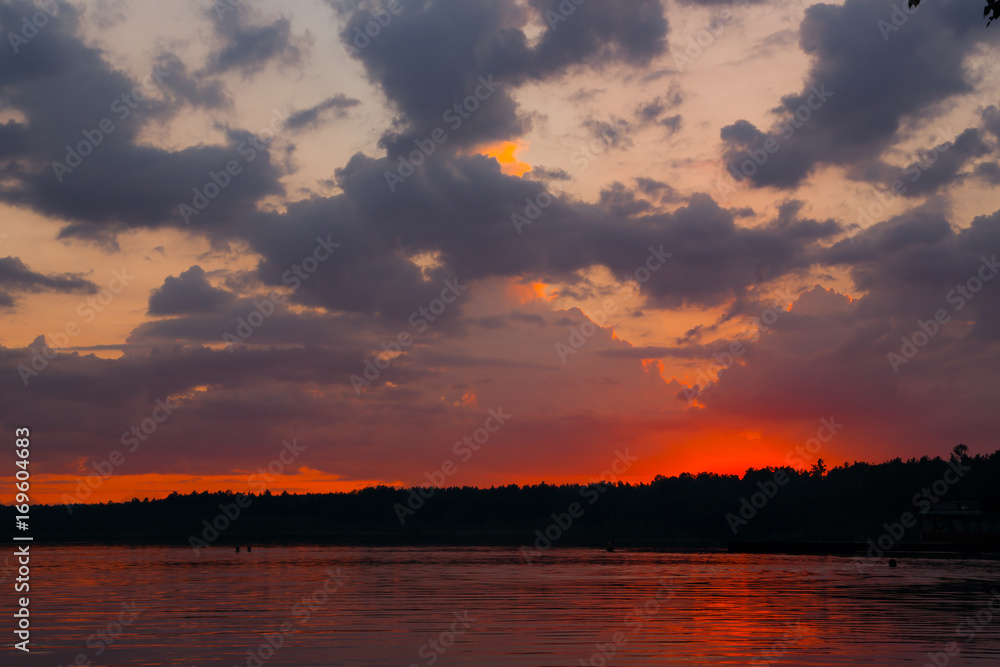 Red beautiful landscape with the sunset on the Urals lake