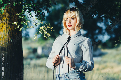 Girl in a shirt and tie with the nature photo