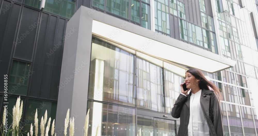 Woman using smartphone walking in city Woman using smartphone walking in city