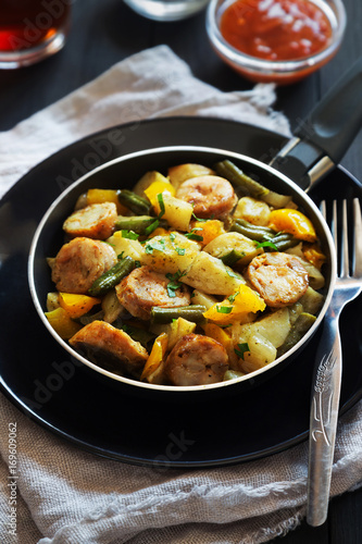 Fried potatoes with sausages and pepper