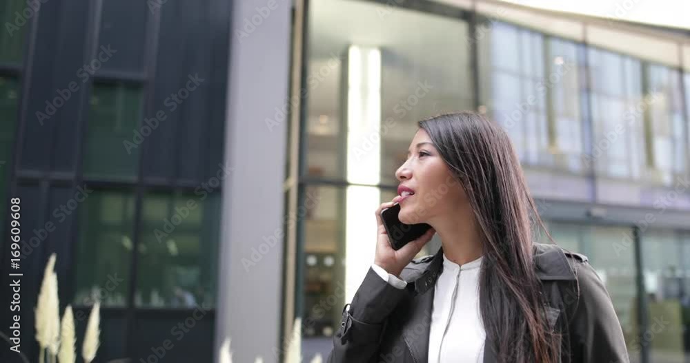 Businesswoman on smartphone looking around Businesswoman on smartphone looking around