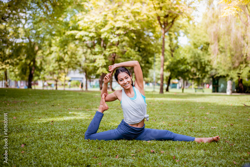 Asian woman practicing yoga in a garden. healthy lifestyle and relaxation