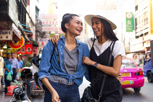 Girlfriends are hanging out on the street in chinatown, Bangkok photo
