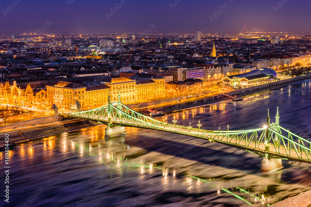 Hungarian sights. Beautiful night view of Liberty bridge over the Danube river in the historic part of Budapest, Hungary.