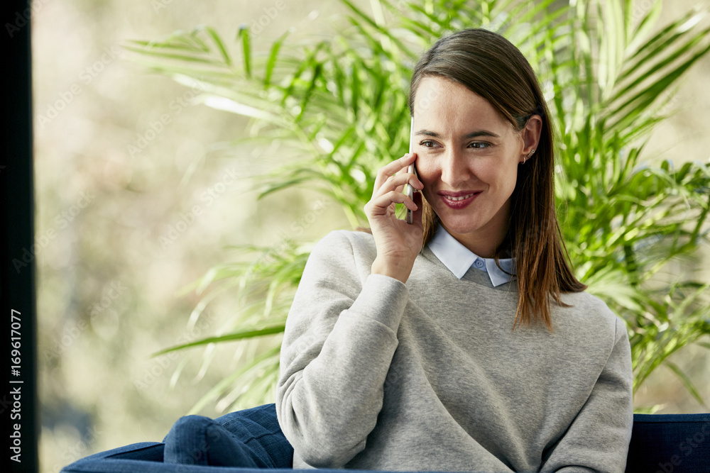 Happy Businesswoman Using Mobile Phone On Chair Happy Businesswoman Using Mobile Phone On Chair