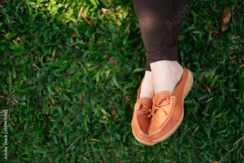 Shoes on green grass with copy space.