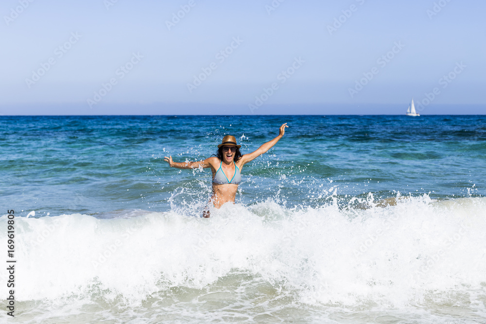 young beautiful woman having fun in the sea and crashing waves. summer. holidays young beautiful woman having fun in the sea and crashing waves. summer. holidays