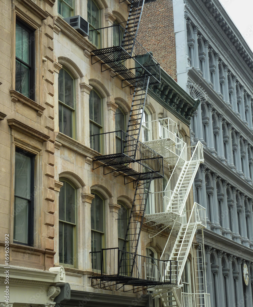 Old residential building with typical fire stairs to escape in Soho district, New York City