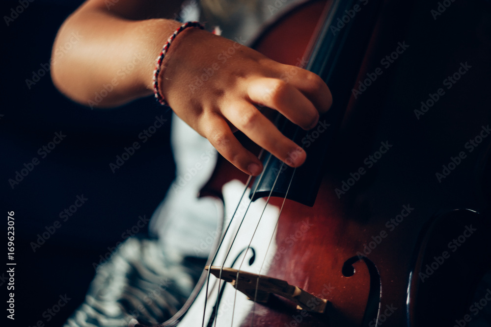 Close up of child playing cello Close up of child playing cello