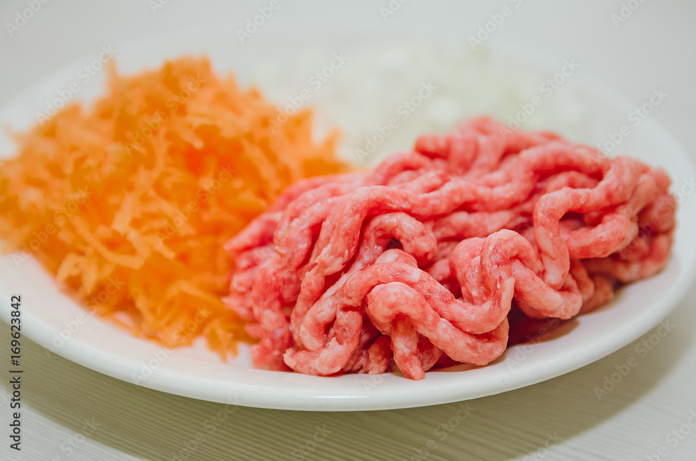 Raw minced meat and fresh vegetables. Ingredients for home cooking.