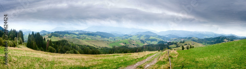 Summertime rural landscape banner, panorama - view at dirt road against the background of mountains Western Carpathians, Zilina Region in the Slovakia © rustamank