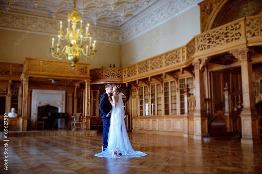 Wedding couple indoors is hugging each other