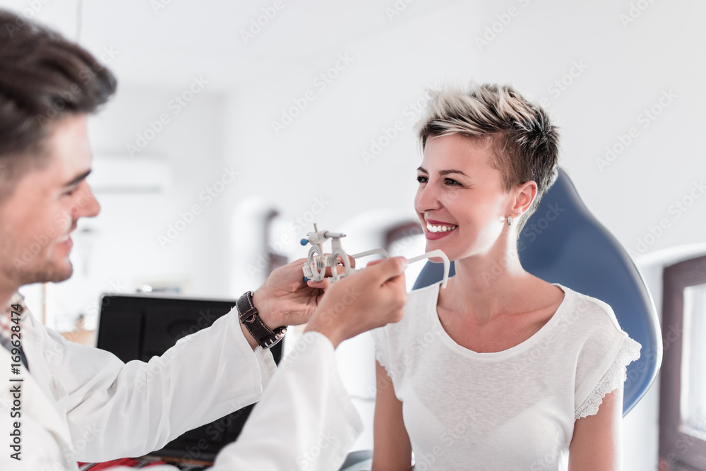 Male optometrist checking patient's vision at eye clinic. Medical examination. Male optometrist checking patient's vision at eye clinic. Medical examination.