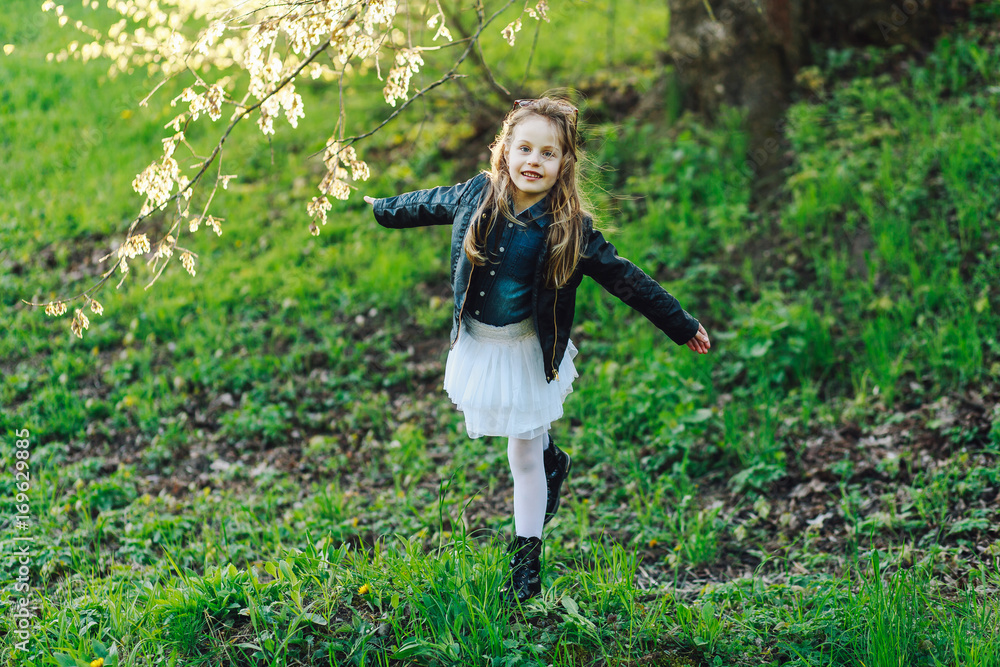 trendy emotional little girl in black boots. Funny girl with open mouth looking at camera trendy emotional little girl in black boots. Funny girl with open mouth looking at camera